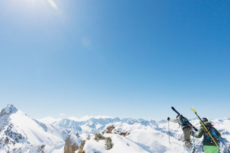 hiking up a snow-covered mountain with ski gear.